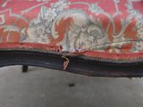 a red and black chair with a red cushion on it