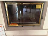 a microwave oven with a glass door and a sign on it
