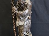 chinese bronze statue of a man holding a staff and a bird