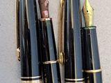 two pens sitting next to each other on a table