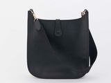 a black leather shoulder bag on a white background