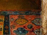 a painting of a cat sitting on a rug in front of a mirror