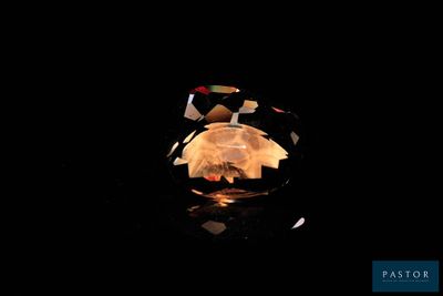 a close up of a ring on a table with a black background