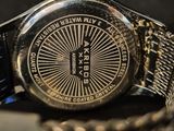 a close up of a watch on a table