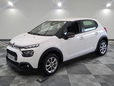 the white citrole is parked on a checkered tile floor