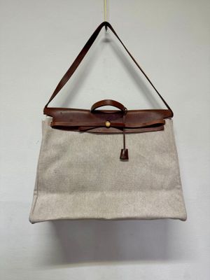 beige and brown handbag hanging on a wall
