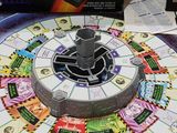 a game board with a clock on it on a table