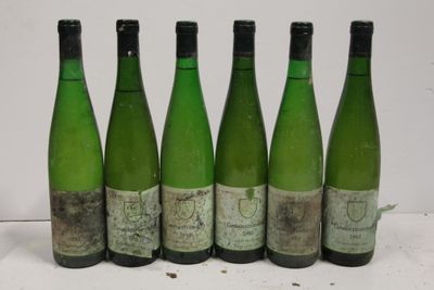 six bottles of wine are lined up in a row on a table
