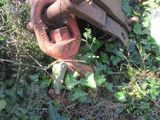 an old rusted out machine sitting in the grass