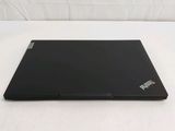 a black laptop sitting on a white surface