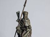 bronze statue of a man on a horse with a spear and shield