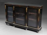 a black and gold decorated cabinet with glass doors