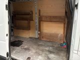 a white van that has a small bed inside of it