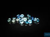 a bunch of blue and white diamonds on a black surface