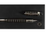 a pair of pens sitting on top of a black envelope