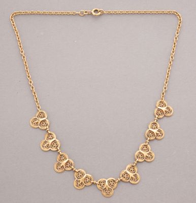 a gold plated necklace with circular medallions on a chain