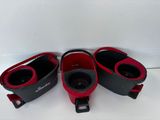 three pairs of red and black leather shoes on a white surface
