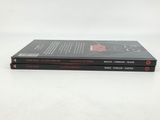 two books are stacked on top of each other on a white surface