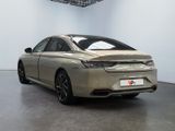the rear end of a silver car in a white room