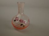 a glass vase with flowers in it sitting on a table