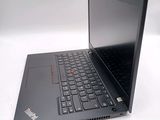 a laptop with a black keyboard on a white surface
