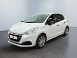 La voiture blanche est garée dans une grande pièce au sol noir.