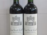 two bottles of wine sitting on top of a counter next to each other