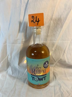 a bottle of rum that is sitting on a white sheet
