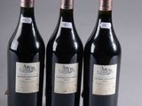 three bottles of wine sitting next to each other on a table