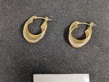 deux paires de boucles d'oreilles en anneau dorées sur un chapeau noir