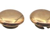 pair of brass knobs on a white background