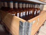many bottles of wine sitting in a wooden crate