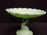an image of a green glass bowl on a black surface