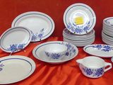 a lot of plates and bowls on the table