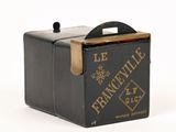 an old black box with a handle on a white surface