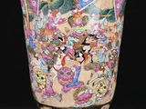 a vase with a painting on it sitting on a wooden stand