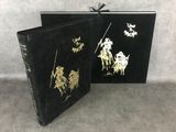 a black book with gold foil on it and a black cover
