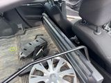 the inside of a car with a steering wheel and a wheel lock