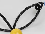 a yellow ball with a black ribbon around it and a blue and yellow ball