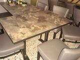 a marble table with chairs around it in a room