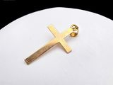 gold plated cross pendant on a white cloth