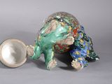 porcelain figurine of a turtle with a bowl in its mouth