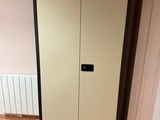 a tall cabinet in the corner of a room