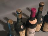 several bottles of wine are lined up in a row on a table