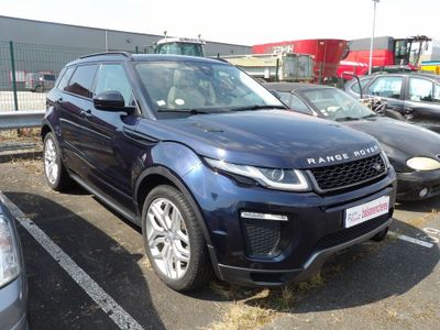 a blue range rover parked in a parking lot