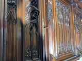 a large wooden cabinet that has carvings on it