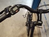 a close up of a bicycle handlebar with a bike in the background