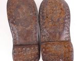 pair of old worn leather shoes on a white surface