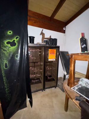a black shirt hanging on a rack in a room