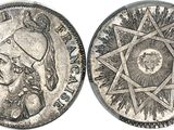 a close up of two silver coins with a star on one side and a star on the other